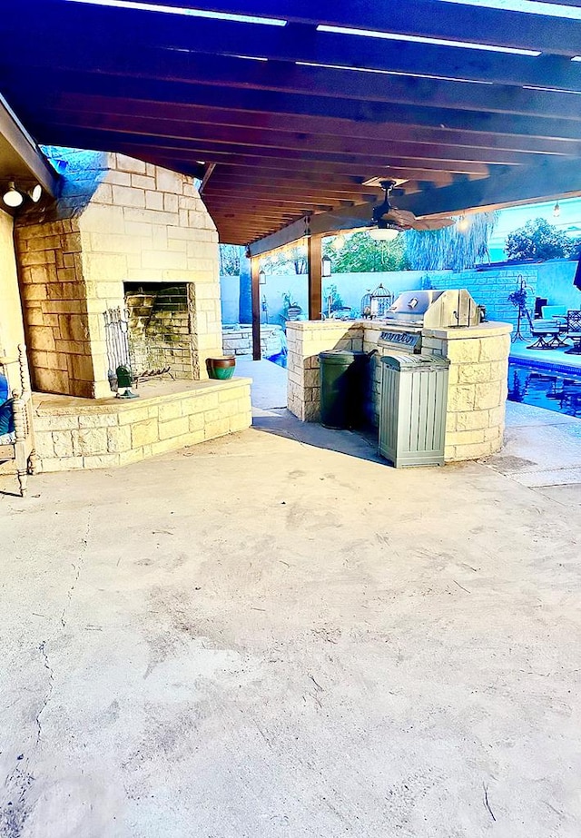 2919 Kirkwood Dr, Odessa, TX 79762 - view of patio / terrace featuring exterior kitchen, a ceiling fan, and exterior fireplace