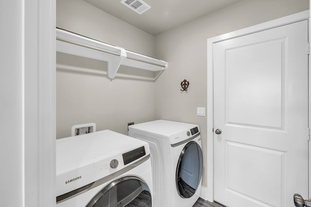 clothes washing area featuring laundry area, independent washer and dryer, and visible vents