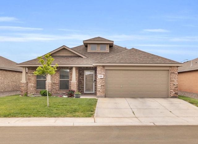 view of front of home featuring roof with shingles, an attached garage, brick siding, driveway, and a front lawn