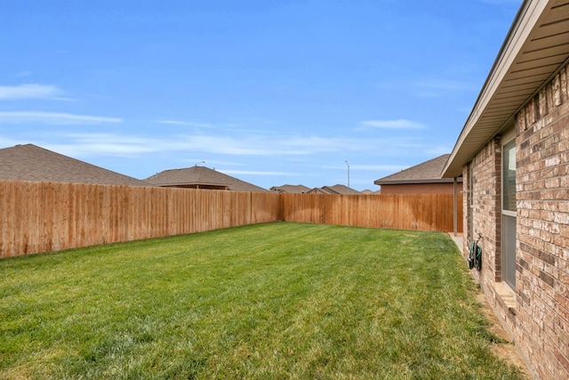 view of yard with a fenced backyard