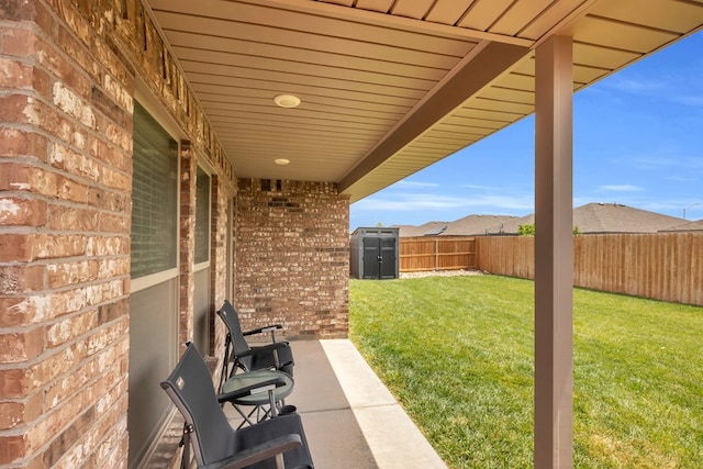 view of yard with an outdoor structure, a fenced backyard, and a storage unit
