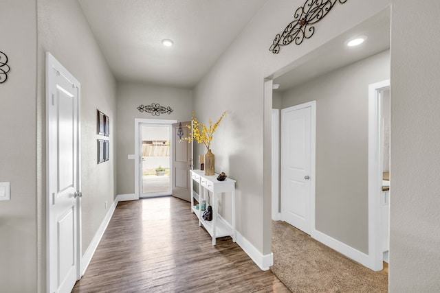 foyer with wood finished floors, baseboards, and recessed lighting