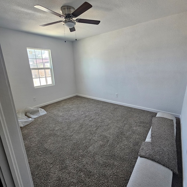 1310 S Emerson Ave, Mccamey, TX 79752 - carpeted spare room featuring a ceiling fan, a textured ceiling, and baseboards
