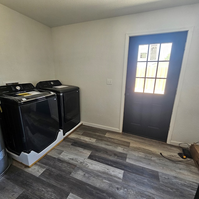 1310 S Emerson Ave, Mccamey, TX 79752 - washroom with washing machine and clothes dryer, dark wood-style floors, and baseboards