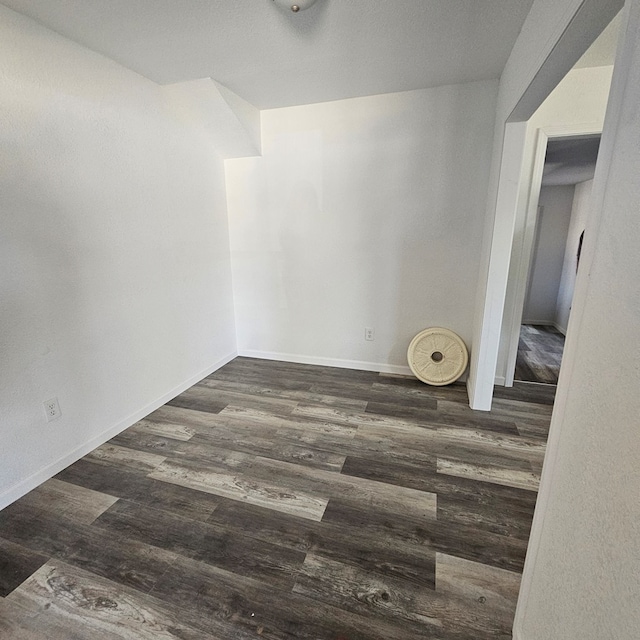 1310 S Emerson Ave, Mccamey, TX 79752 - unfurnished room featuring wood finished floors and baseboards