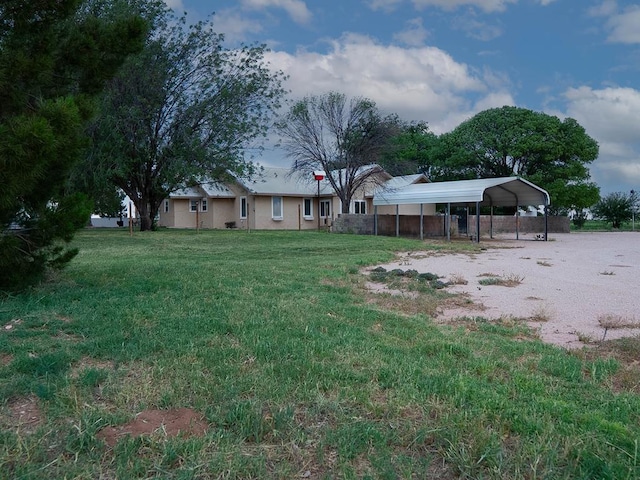 302 County Rd 409, Seminole, TX 79714 - view of grassy yard with a detached carport and driveway