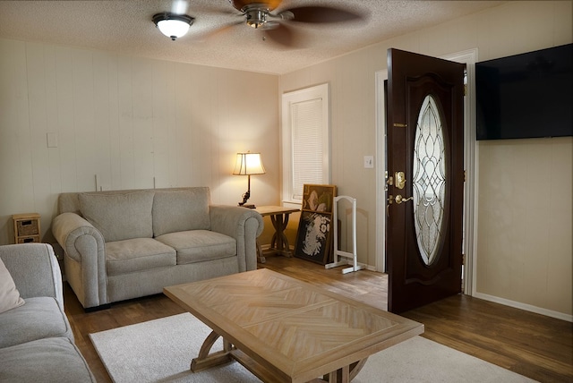 302 County Rd 409, Seminole, TX 79714 - living area with wood finished floors, ceiling fan, and a textured ceiling