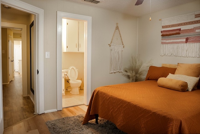 302 County Rd 409, Seminole, TX 79714 - bedroom featuring light wood-style floors, ensuite bathroom, and baseboards
