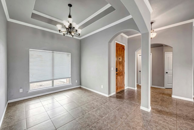 spare room with tile patterned floors, baseboards, a notable chandelier, ornamental molding, and a tray ceiling