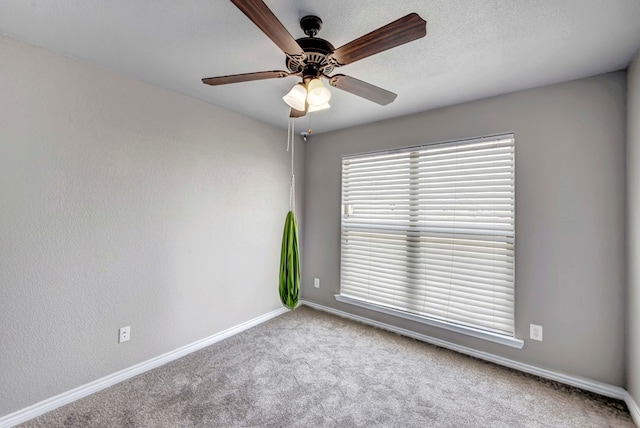 empty room with baseboards, carpet flooring, and ceiling fan