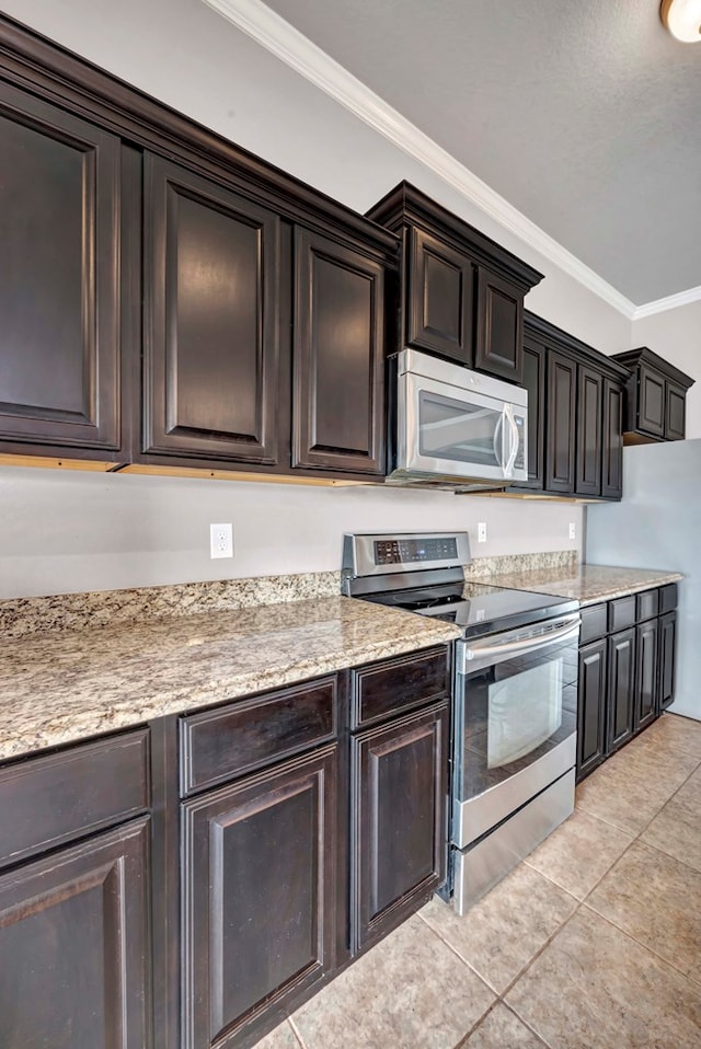 kitchen with crown molding, dark brown cabinets, appliances with stainless steel finishes, and light tile patterned floors