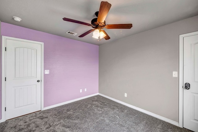 carpeted spare room with ceiling fan, visible vents, and baseboards