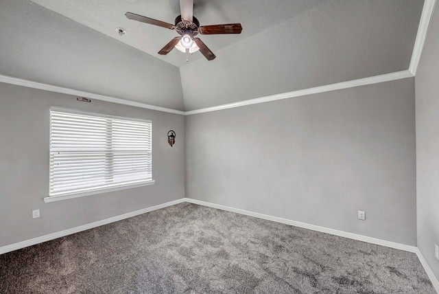 spare room with carpet floors, a ceiling fan, baseboards, and vaulted ceiling
