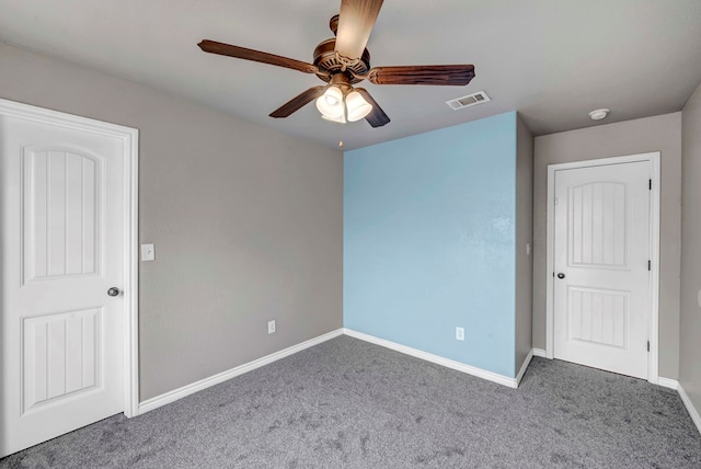 unfurnished bedroom with carpet floors, a ceiling fan, baseboards, and visible vents