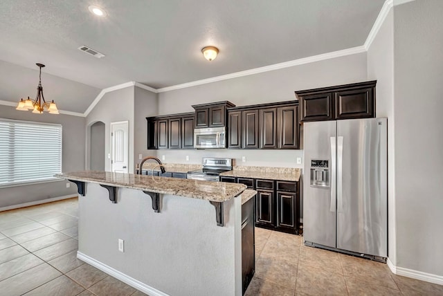 kitchen featuring a breakfast bar, arched walkways, stainless steel appliances, lofted ceiling, and visible vents