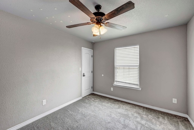 empty room with baseboards, carpet, and ceiling fan