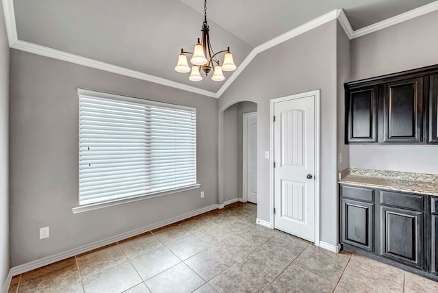 unfurnished dining area with arched walkways, vaulted ceiling, baseboards, a chandelier, and ornamental molding