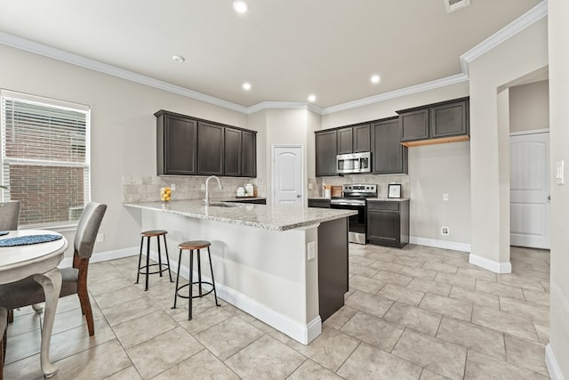 8919 Red Cliff Ave, Odessa, TX 79765 - kitchen with stainless steel appliances, tasteful backsplash, a peninsula, light stone countertops, and recessed lighting