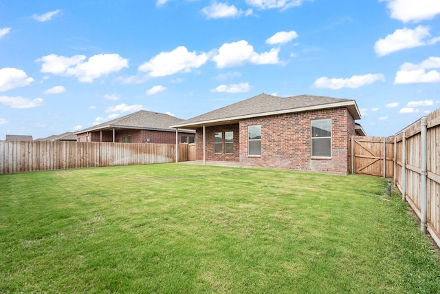 8919 Red Cliff Ave, Odessa, TX 79765 - rear view of house featuring brick siding, a fenced backyard, and roof with shingles