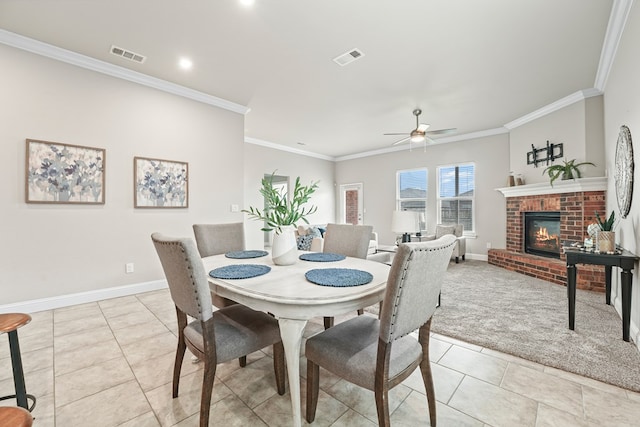 8919 Red Cliff Ave, Odessa, TX 79765 - dining area featuring light tile patterned flooring, a ceiling fan, ornamental molding, a fireplace, and light colored carpet
