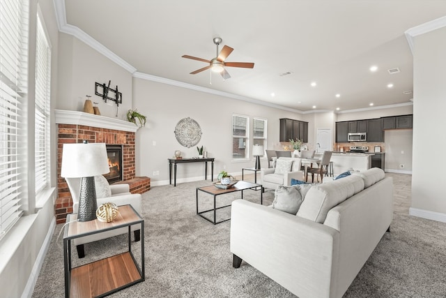 8919 Red Cliff Ave, Odessa, TX 79765 - living room with light colored carpet, a ceiling fan, a fireplace, crown molding, and recessed lighting