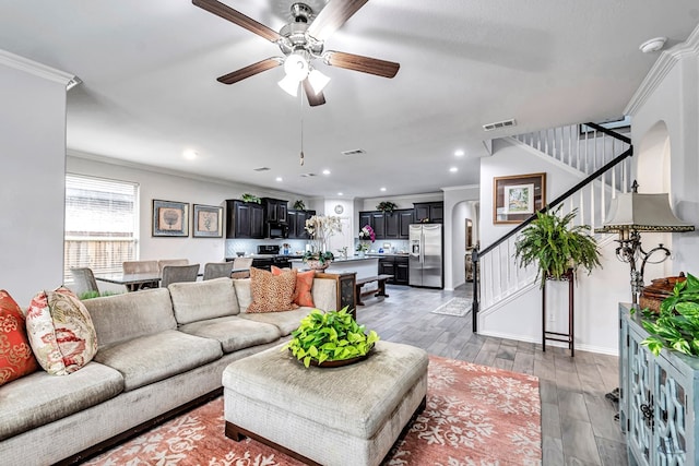 7016 Spur Ranch Rd, Odessa, TX 79765 - living room featuring stairs, ceiling fan, arched walkways, crown molding, and recessed lighting