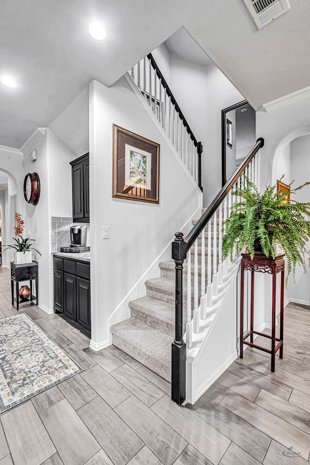 7016 Spur Ranch Rd, Odessa, TX 79765 - stairs with arched walkways, ornamental molding, and recessed lighting
