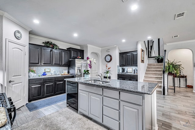 7016 Spur Ranch Rd, Odessa, TX 79765 - kitchen with stainless steel fridge, arched walkways, crown molding, dishwasher, and tasteful backsplash