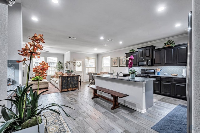 7016 Spur Ranch Rd, Odessa, TX 79765 - kitchen featuring black microwave, electric range oven, ornamental molding, open floor plan, and recessed lighting