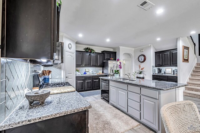 7016 Spur Ranch Rd, Odessa, TX 79765 - kitchen with stainless steel appliances, backsplash, ornamental molding, light wood-style floors, and recessed lighting