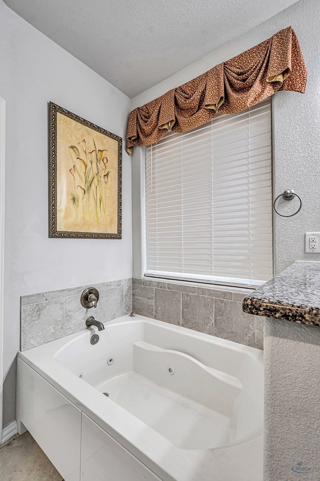 7016 Spur Ranch Rd, Odessa, TX 79765 - full bathroom with a tub with jets and a textured ceiling