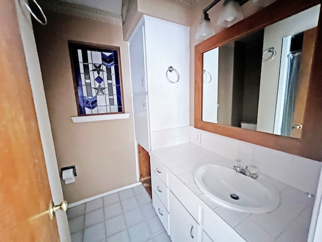 bathroom with tile patterned floors, vanity, and tasteful backsplash