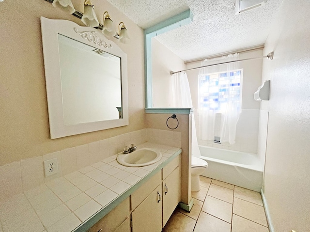 full bathroom featuring vanity, tile patterned flooring, toilet, a textured ceiling, and shower / tub combo