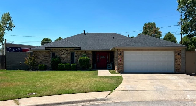 single story home with a garage and a front lawn