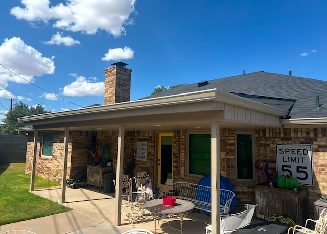 back of property with a patio