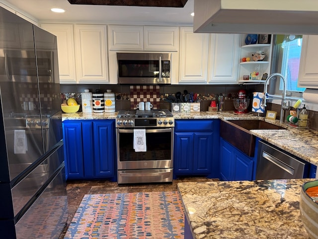 kitchen featuring blue cabinetry, sink, white cabinetry, light stone counters, and stainless steel dishwasher