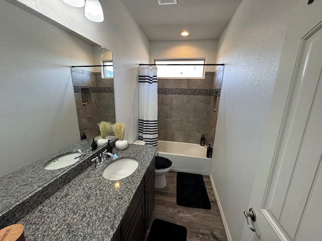 7001 La Escalera Ct, Odessa, TX 79765 - bathroom with wood finished floors, vanity, shower / tub combo with curtain, and a textured wall