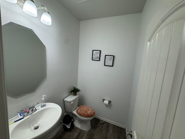 7001 La Escalera Ct, Odessa, TX 79765 - half bath with a sink and wood finished floors