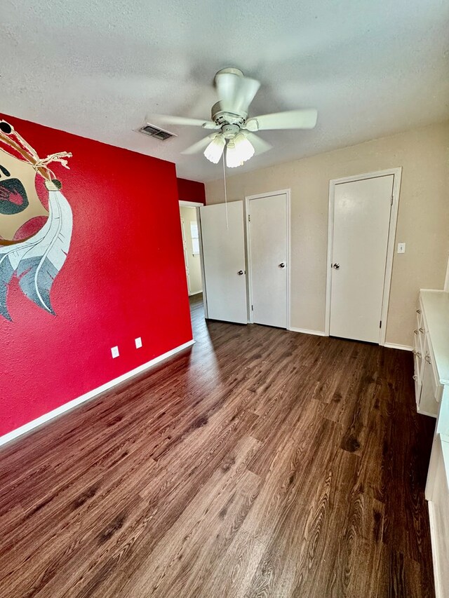 6305 Mecca St, Odessa, TX 79762 - unfurnished bedroom featuring wood finished floors, baseboards, and a ceiling fan