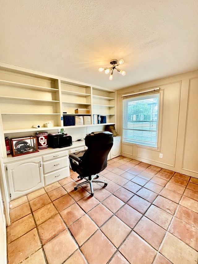 6305 Mecca St, Odessa, TX 79762 - office space featuring built in study area, light tile patterned flooring, a textured ceiling, and built in shelves