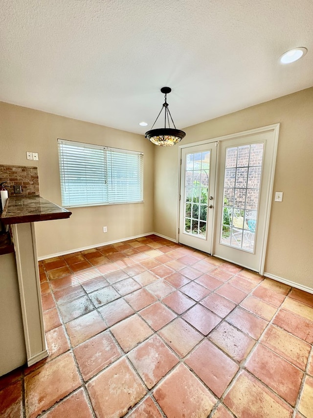 6305 Mecca St, Odessa, TX 79762 - unfurnished dining area with baseboards, a textured ceiling, and recessed lighting