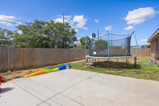 1012 Duke Ave, Odessa, TX 79765 - fenced backyard with a trampoline and a patio