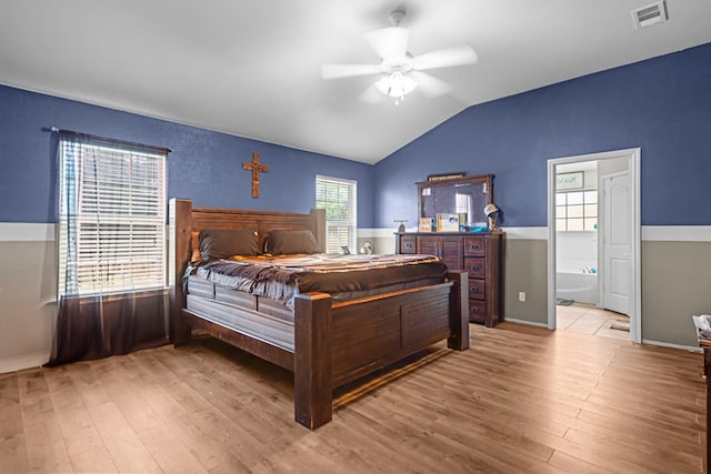 1012 Duke Ave, Odessa, TX 79765 - bedroom featuring wood finished floors, lofted ceiling, ceiling fan, and ensuite bathroom