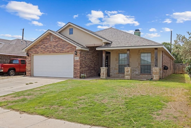 1012 Duke Ave, Odessa, TX 79765 - view of front of property with a garage, driveway, a shingled roof, brick siding, and stucco siding
