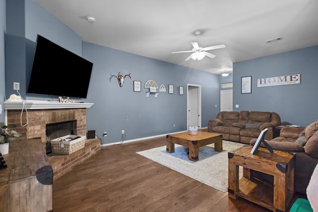 1012 Duke Ave, Odessa, TX 79765 - living room with ceiling fan, wood finished floors, and a brick fireplace