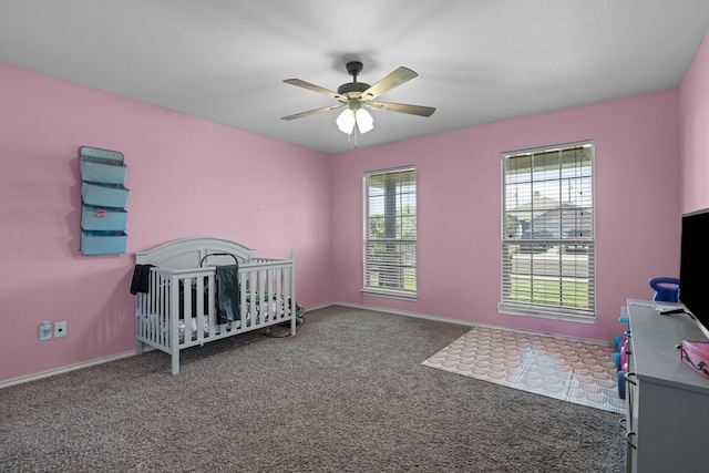 1012 Duke Ave, Odessa, TX 79765 - bedroom with carpet, a crib, and ceiling fan