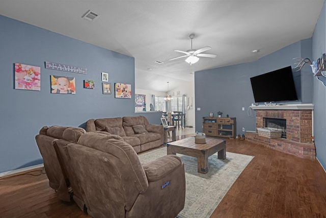 1012 Duke Ave, Odessa, TX 79765 - living room with wood finished floors, ceiling fan, lofted ceiling, and a brick fireplace
