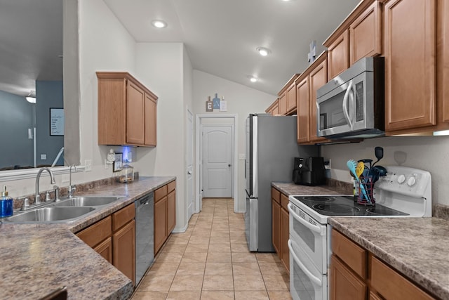 1012 Duke Ave, Odessa, TX 79765 - kitchen with appliances with stainless steel finishes, vaulted ceiling, brown cabinetry, light tile patterned floors, and recessed lighting