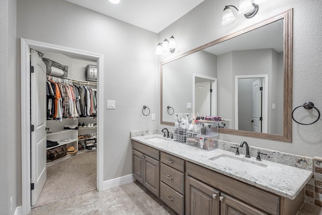 7604 Keyhaven St, Odessa, TX 79765 - full bathroom with double vanity and a spacious closet