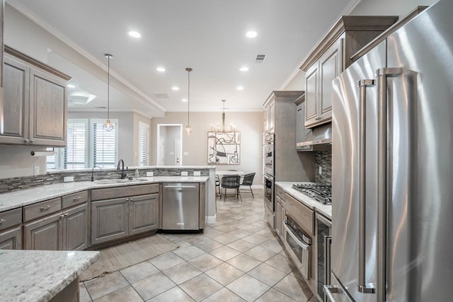7604 Keyhaven St, Odessa, TX 79765 - kitchen featuring appliances with stainless steel finishes, crown molding, a chandelier, recessed lighting, and decorative light fixtures